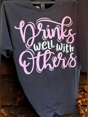 Bella Canvas Black Tee with Pink & White Script "Drinks Well With Others"